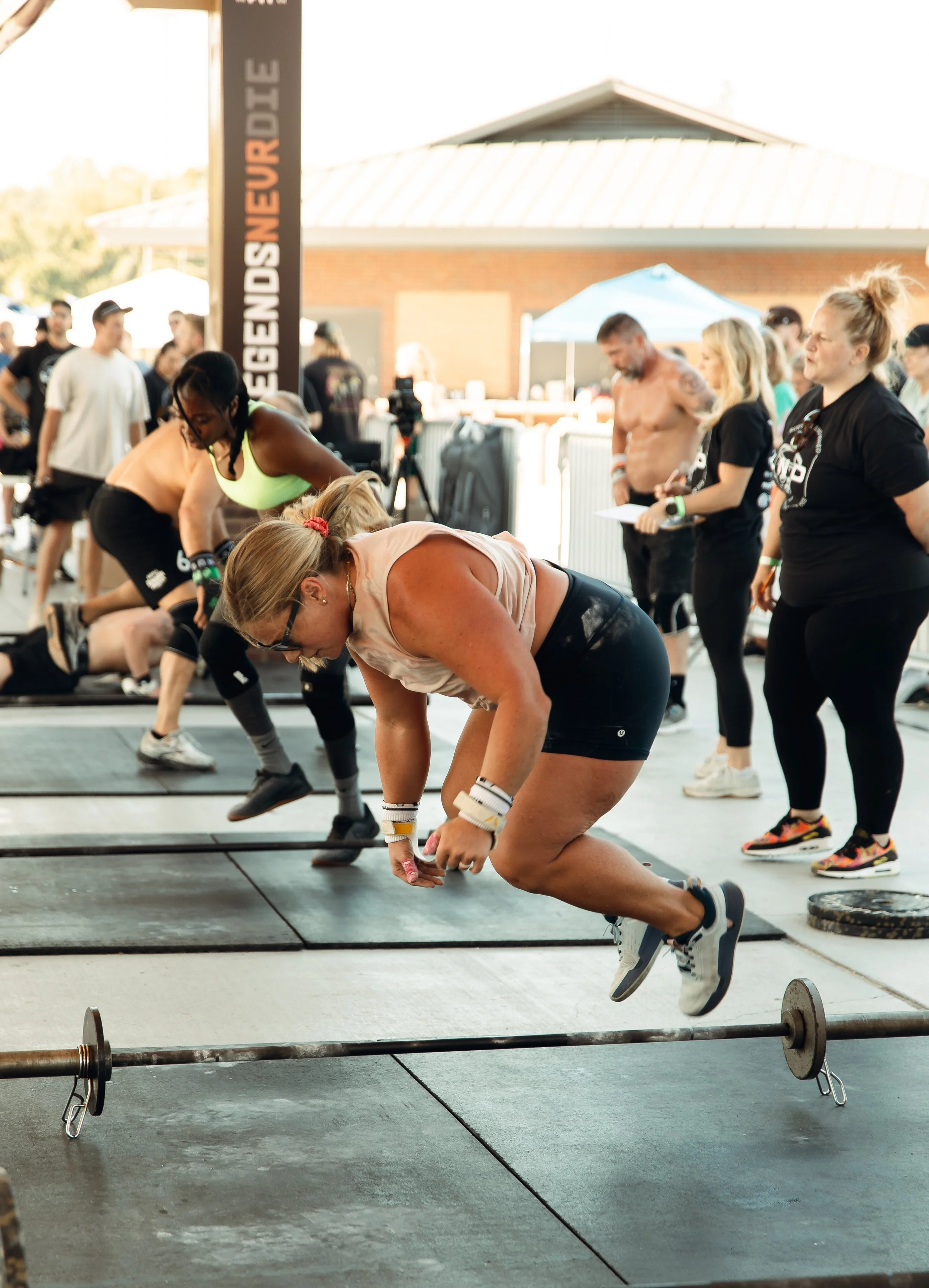 Competitor moving a sandbag across the floor